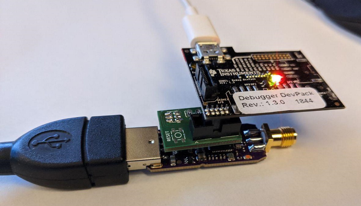 A zzh connected to a TI Debug DevPack through the compact debug adapter